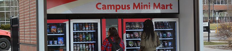 Two students using the Campus Mini Mart.